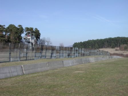 A view on the vehicle wall and border fence on the East German side